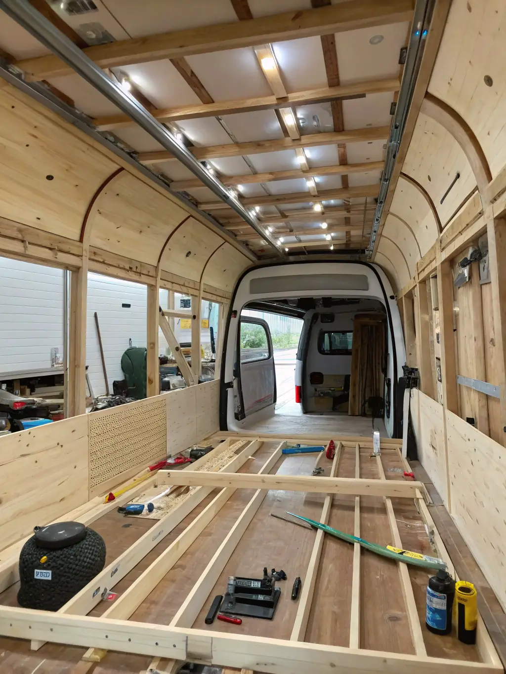 An image of a partially converted van interior with custom cabinetry and insulation, demonstrating van conversion products.